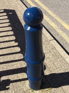 Photograph: The job's finished. The rusty old pavement bollards are now a nice shiny blue colour once again.